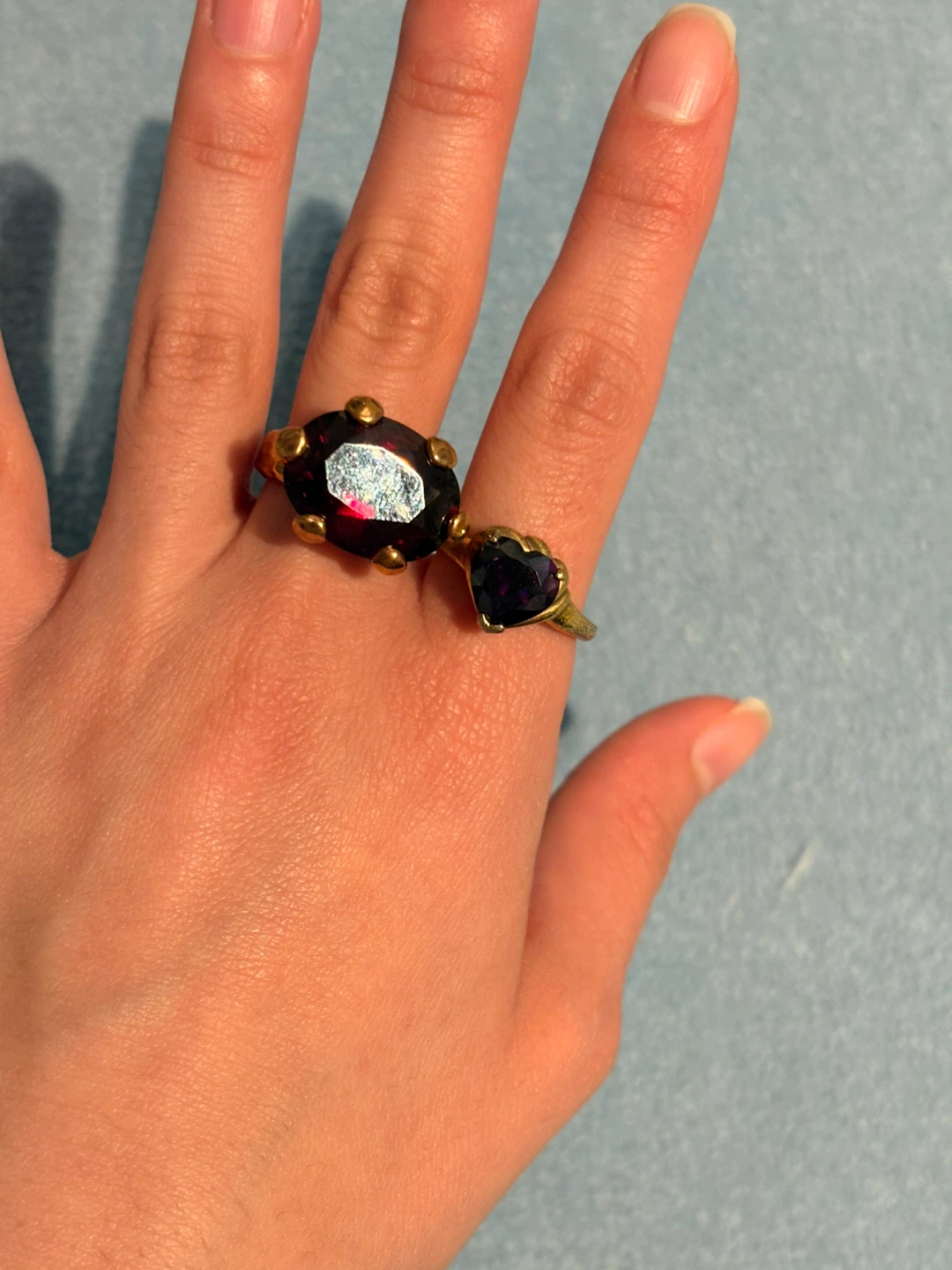 Gold tone rings with deep red and purple stones