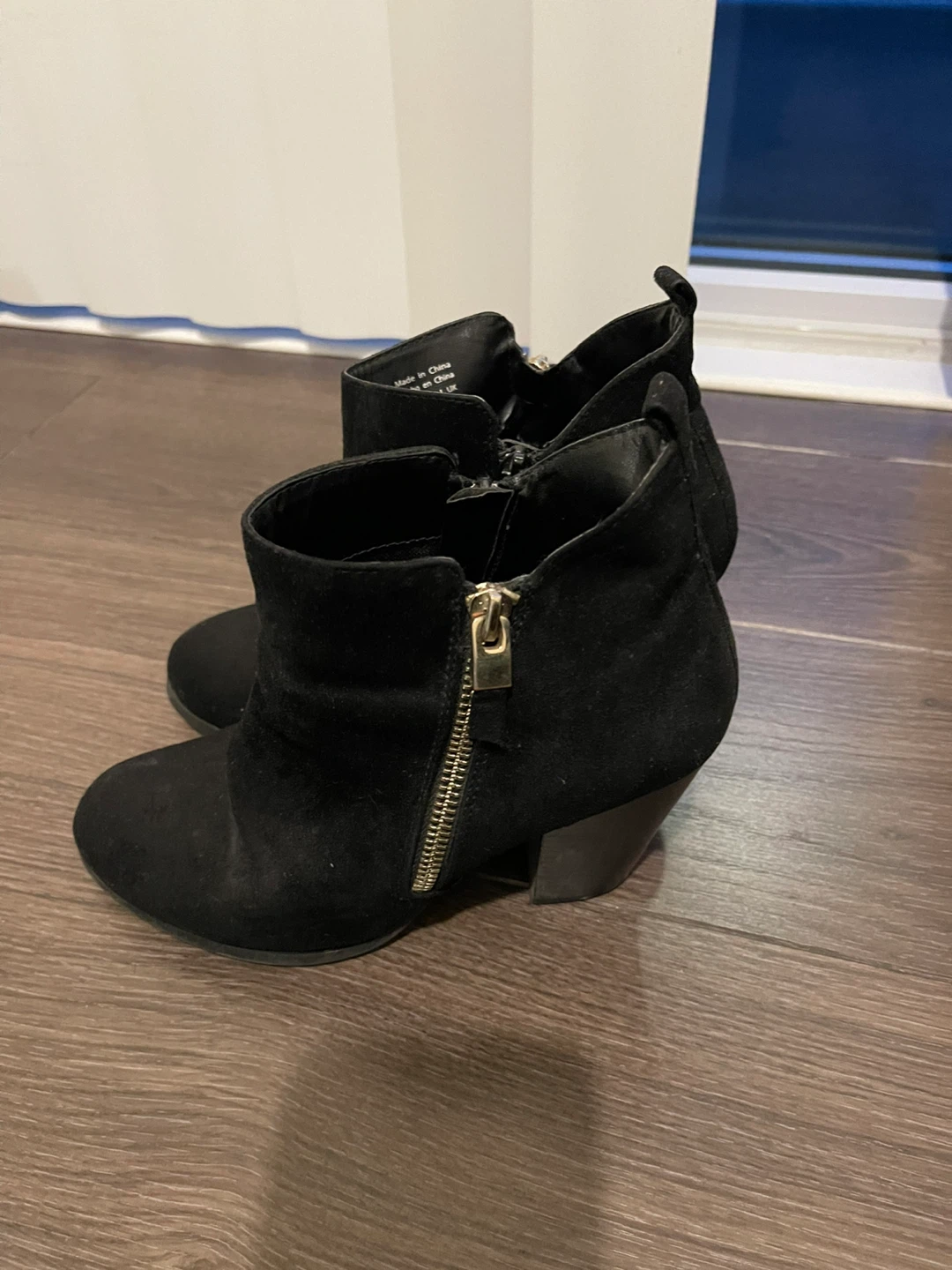 Black ankle heel boots with golden zipper