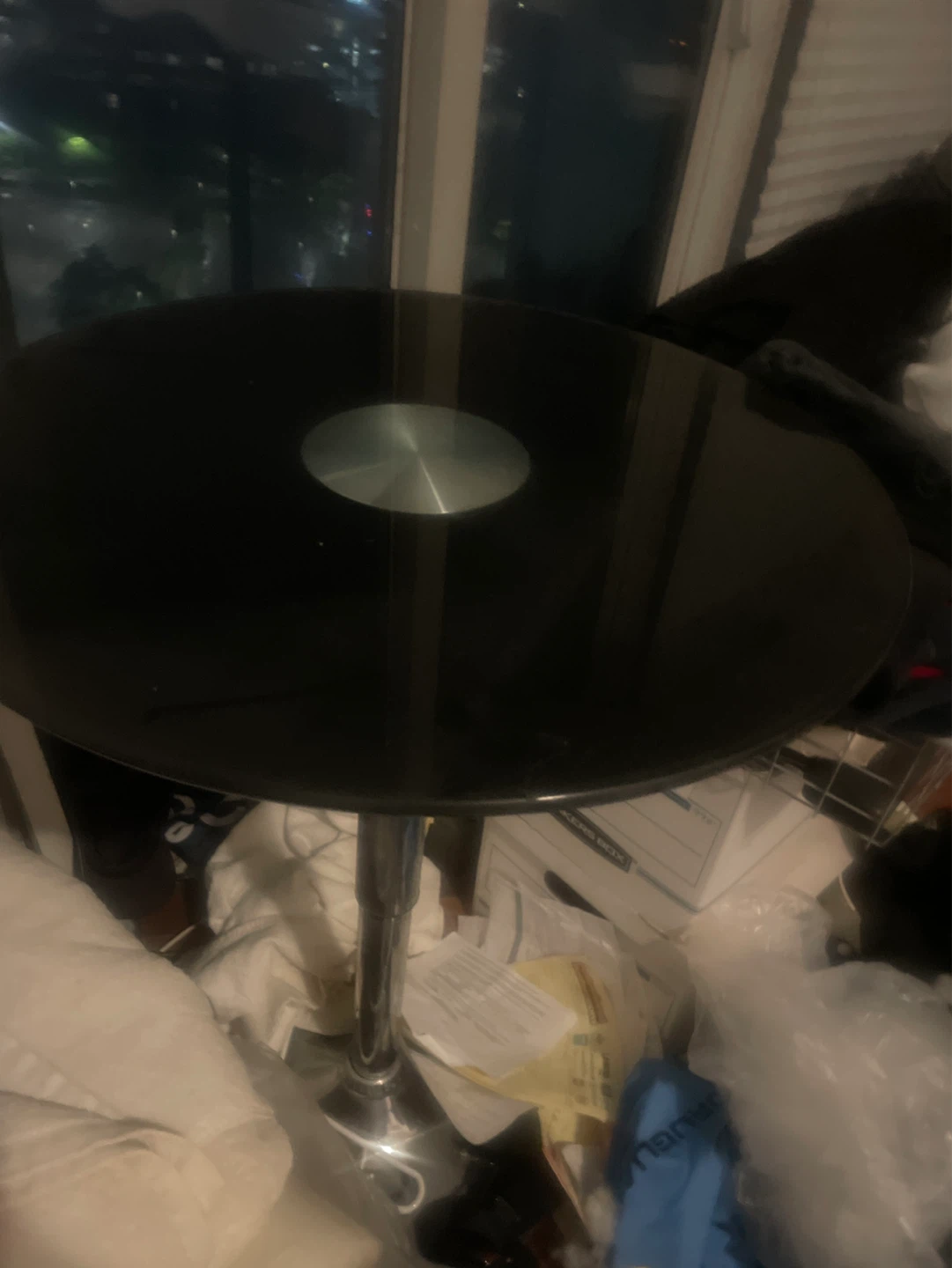 Black round glass top table with chrome base