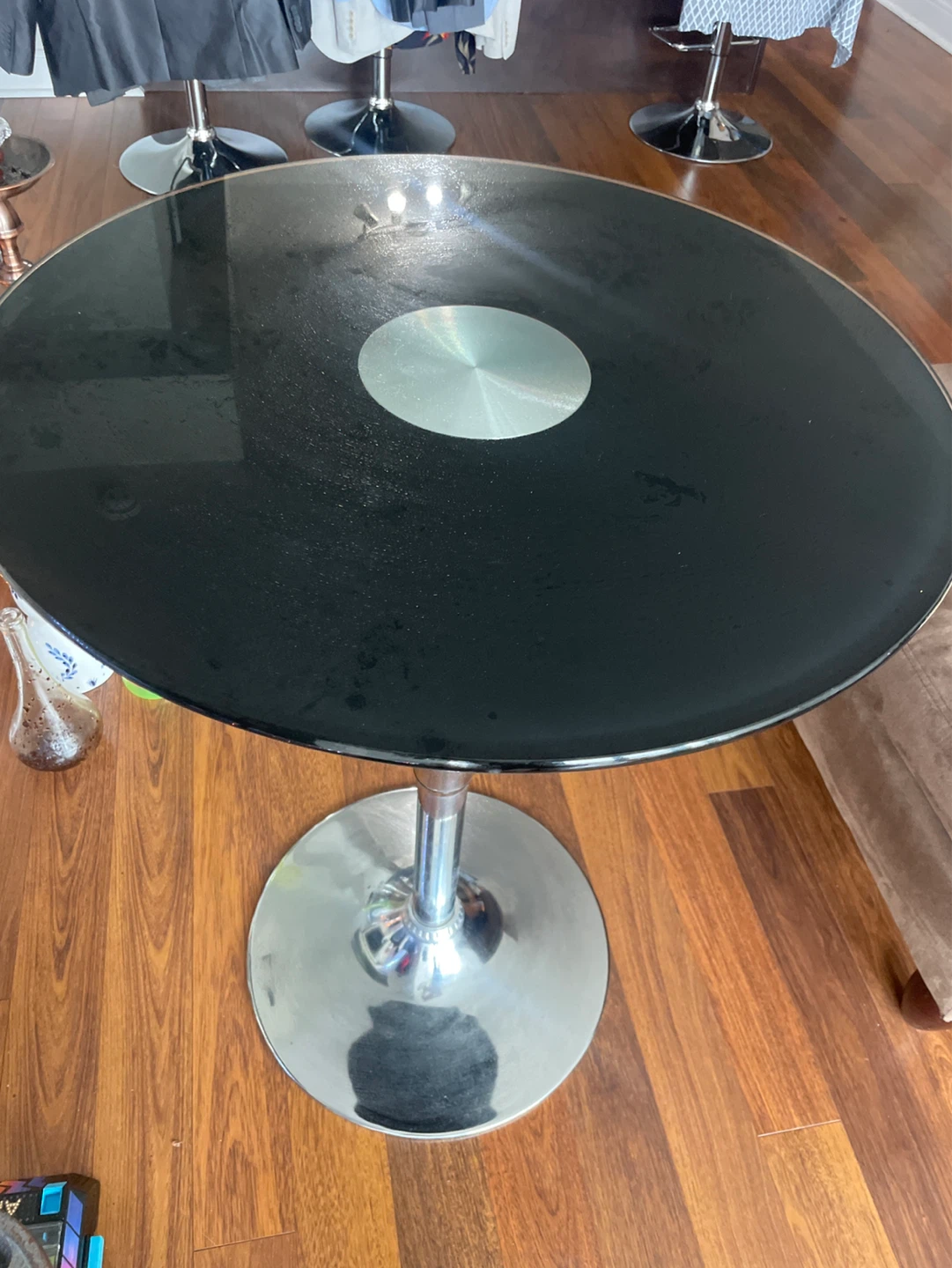 Black round glass top table with chrome base