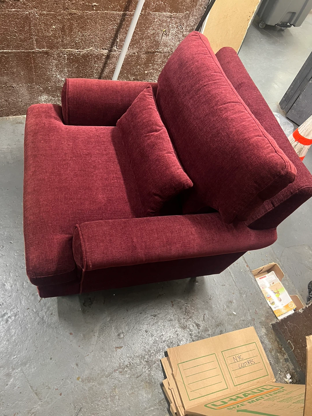 Red Upholstered Armchair with Throw Pillow