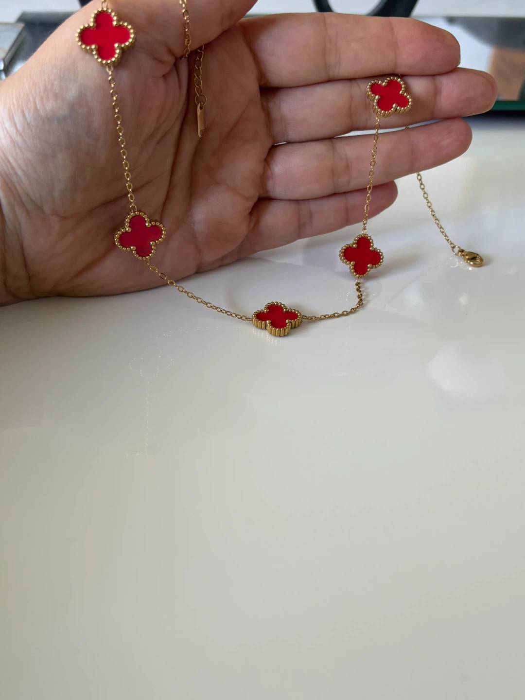 Gold plated -tone necklace with red clover charms