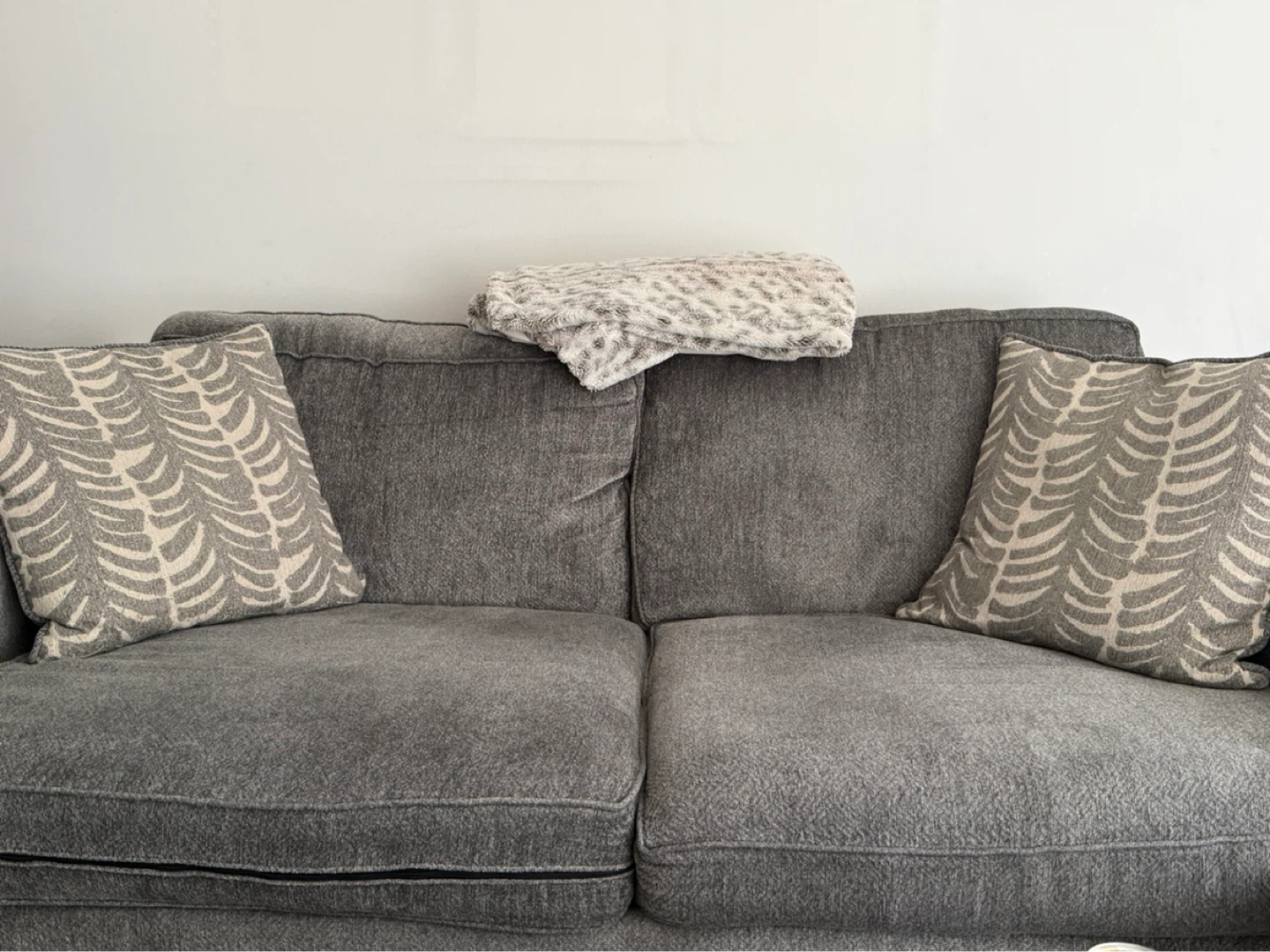 Gray Sofa with Decorative Pillows and blanket