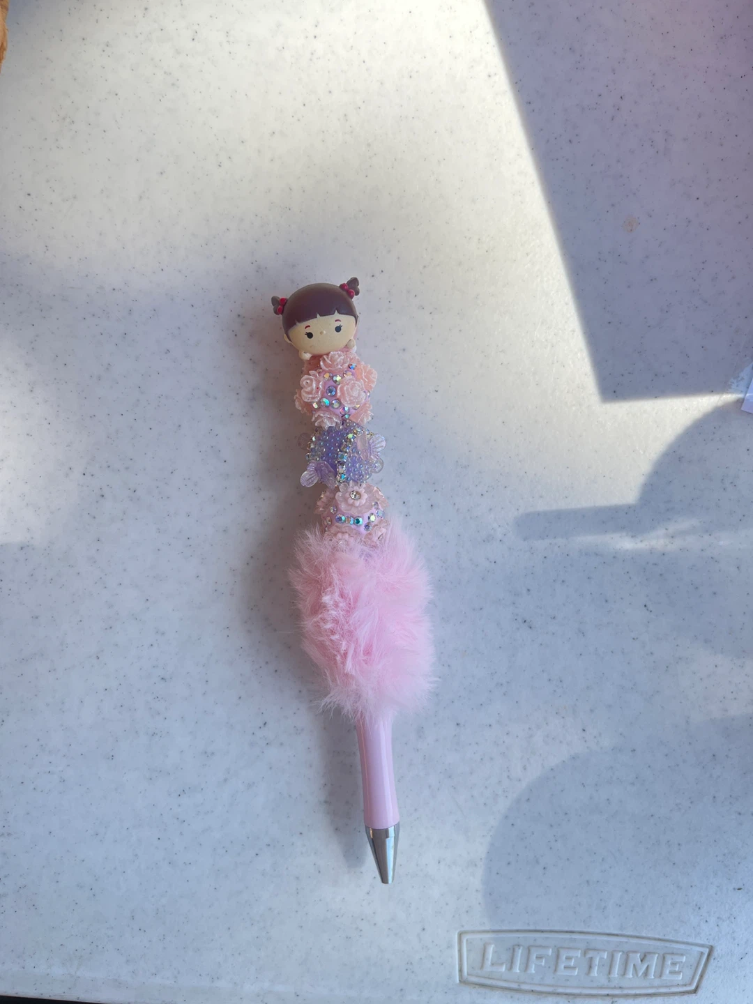 Pink fluffy pen with doll charm