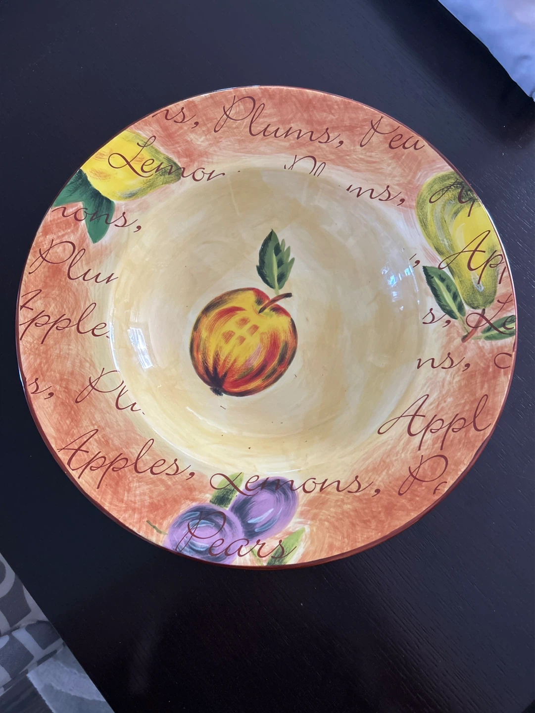 Fruit themed bowl with apples, lemons, plums, and pears