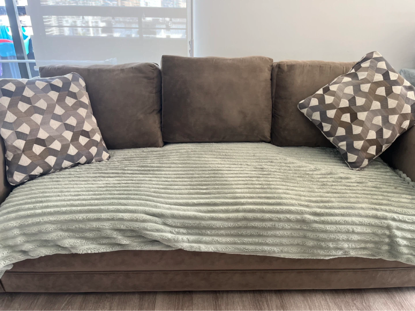 Brown 3 seater Sofa with Decorative Pillows and green throw
