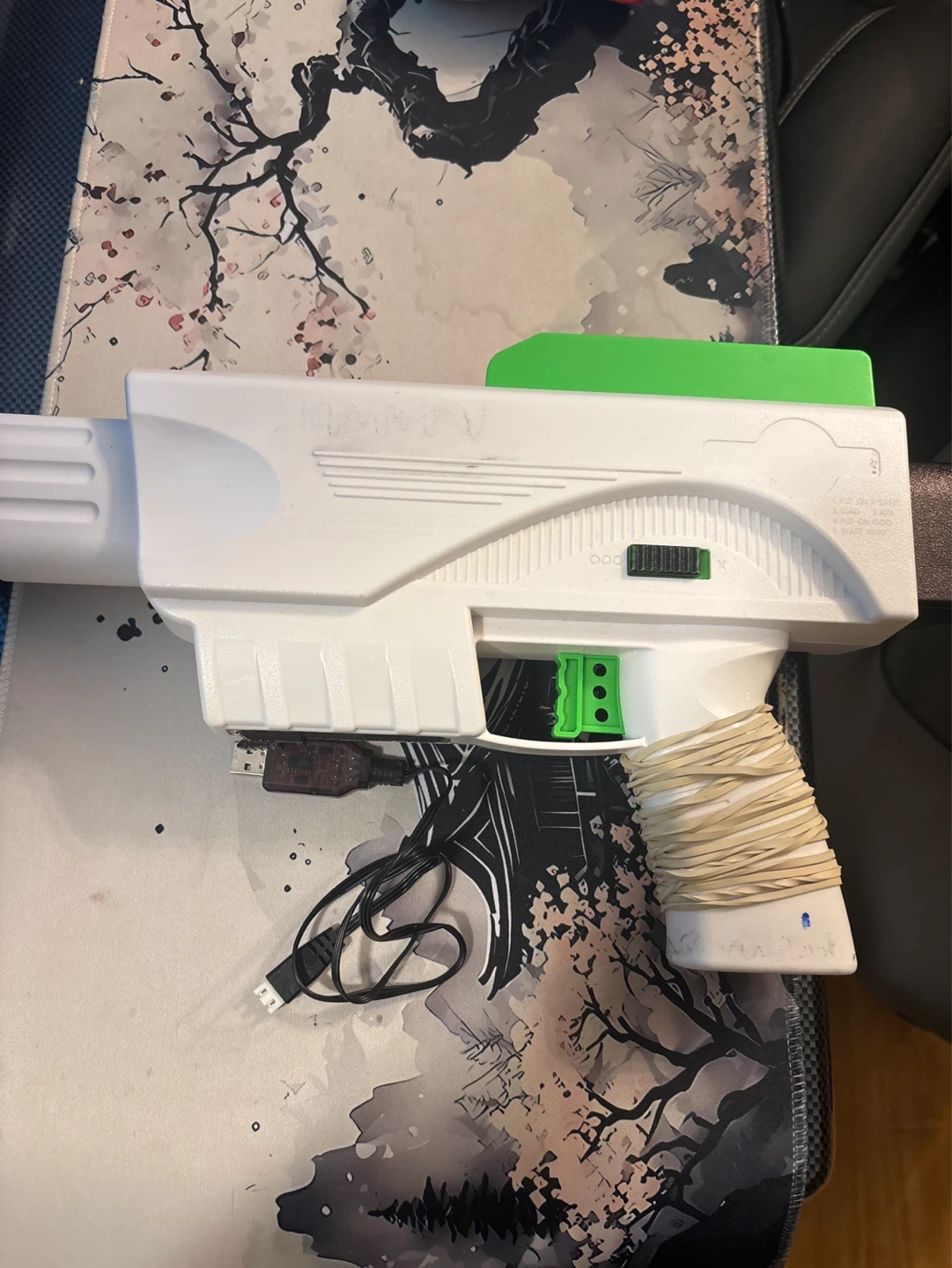 White Toy Blaster with Green Accents and USB Charger