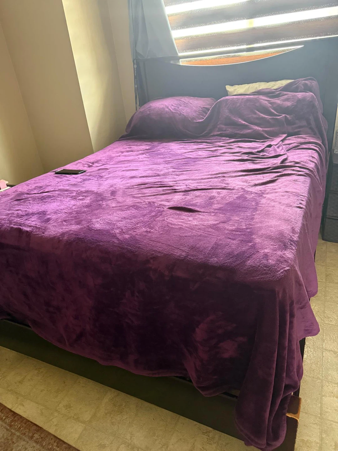 Queen size bed frame with mattress and box spring.