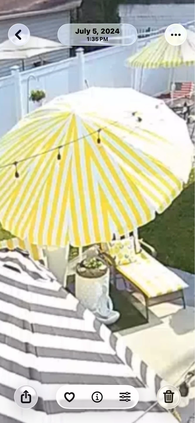 Yellow and White Striped Patio Umbrella and Pillows