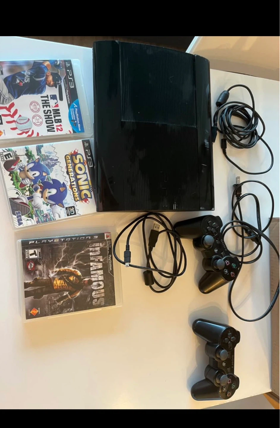 PS3 with two controls and 3 games