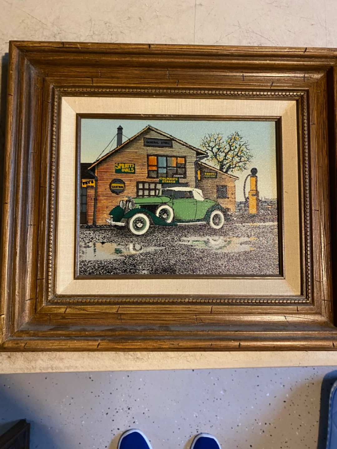 Framed Print of a Vintage Green Car at a General Store