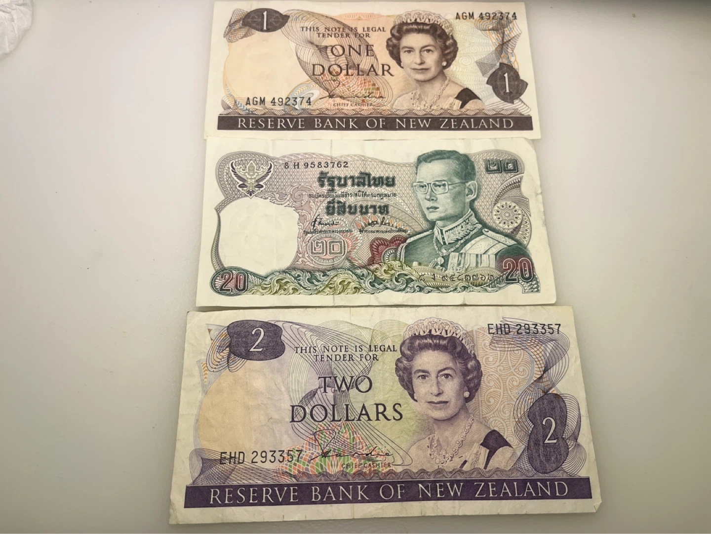 New Zealand Dollar Banknotes - 1, 2 Dollars + Thai 20 Baht