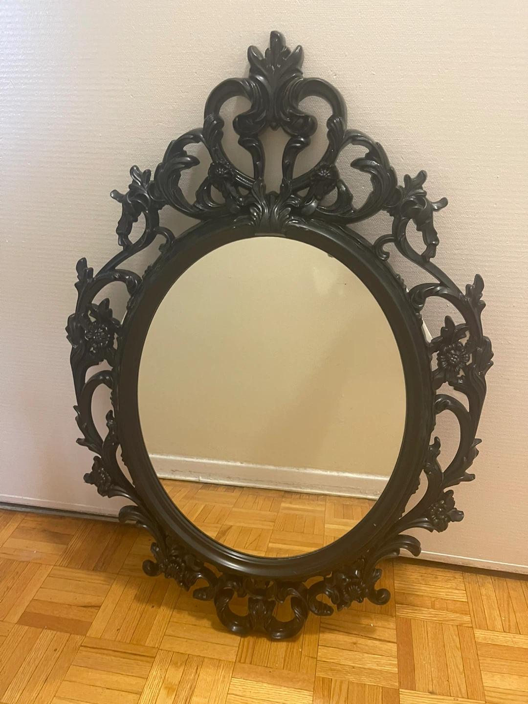 Black ornate oval mirror