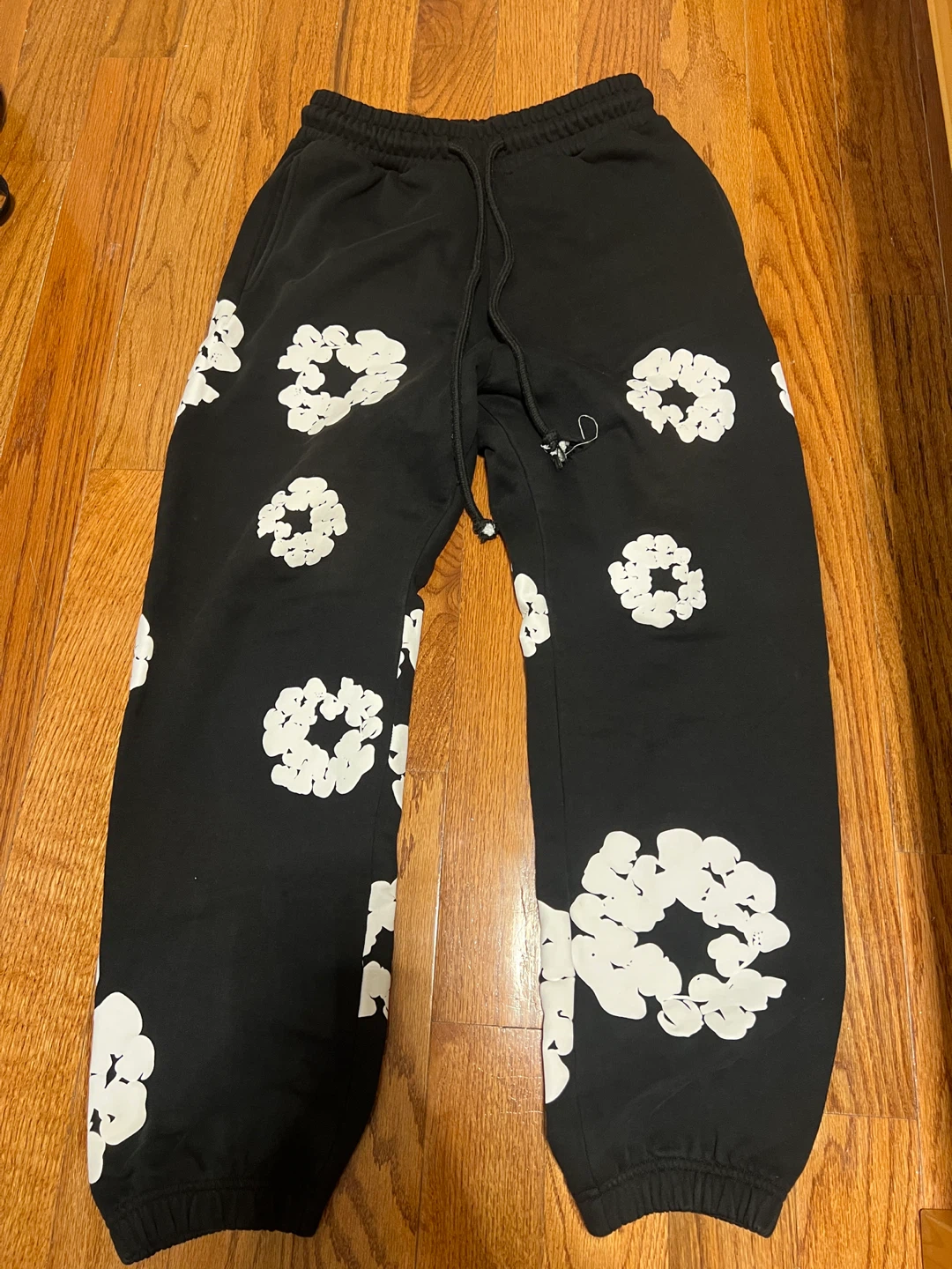 Denim Tears Black Sweatpants with White Floral Print