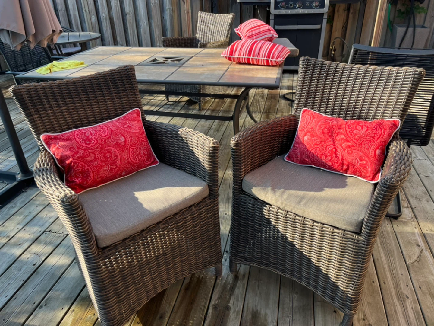 Outdoor Wicker patio chair with red accent pillow