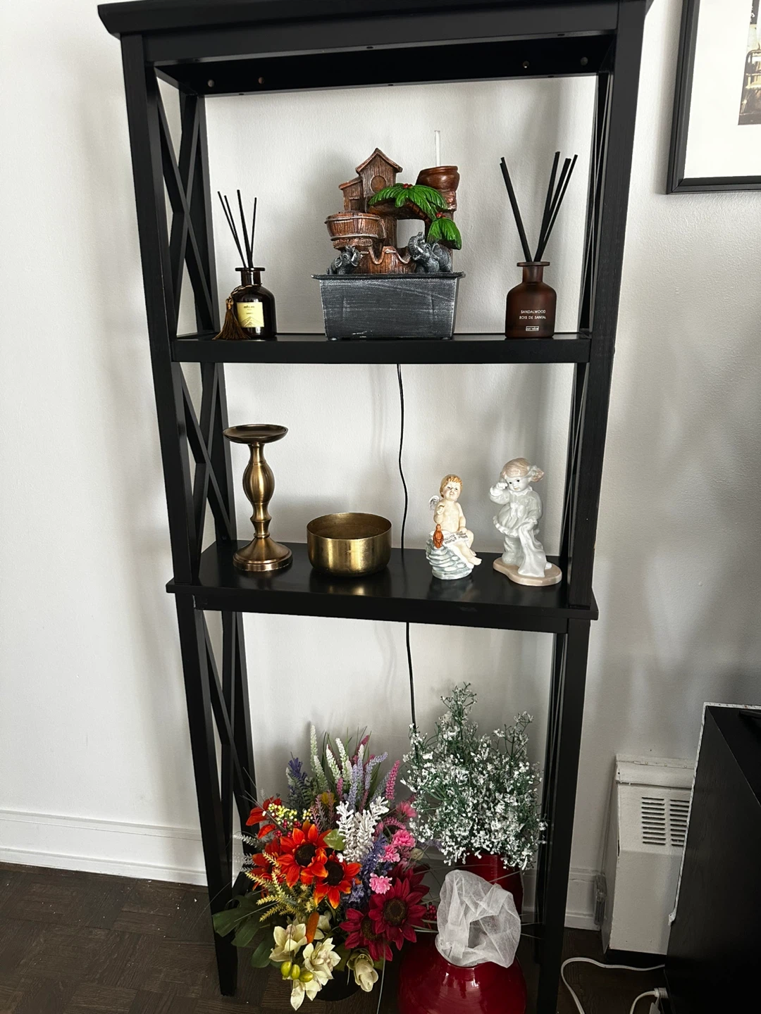 Black leaning bookshelf with decorative items - photo 3