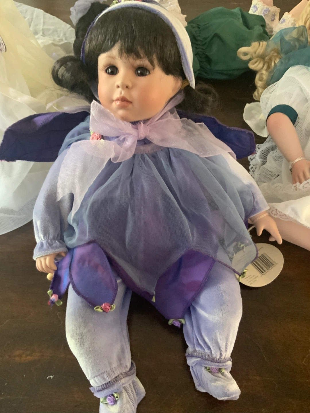 Collection of Porcelain Dolls in Various Outfits - photo 3
