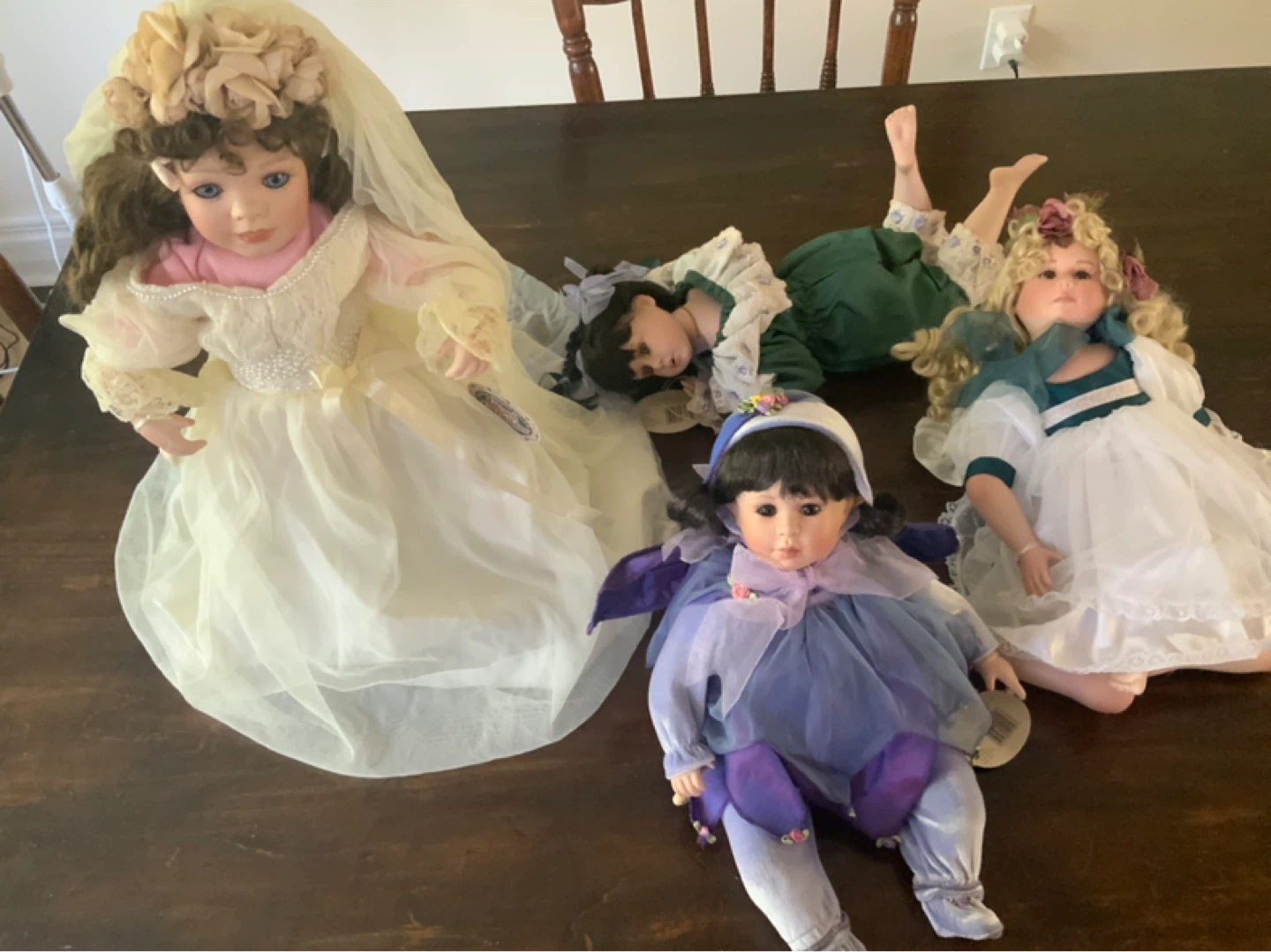 Collection of Porcelain Dolls in Various Outfits