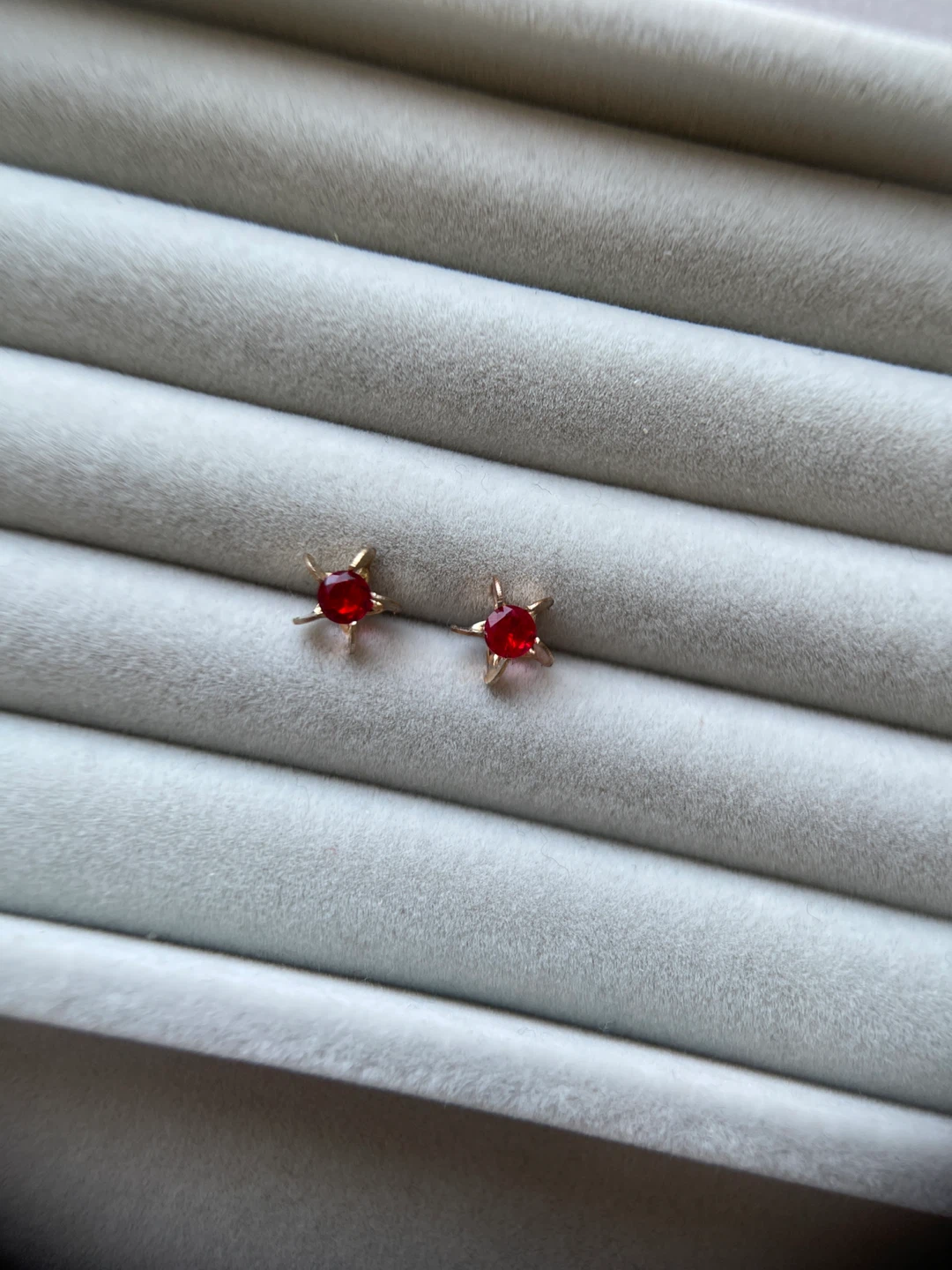 Gold Tone Star Earrings with Red Gems