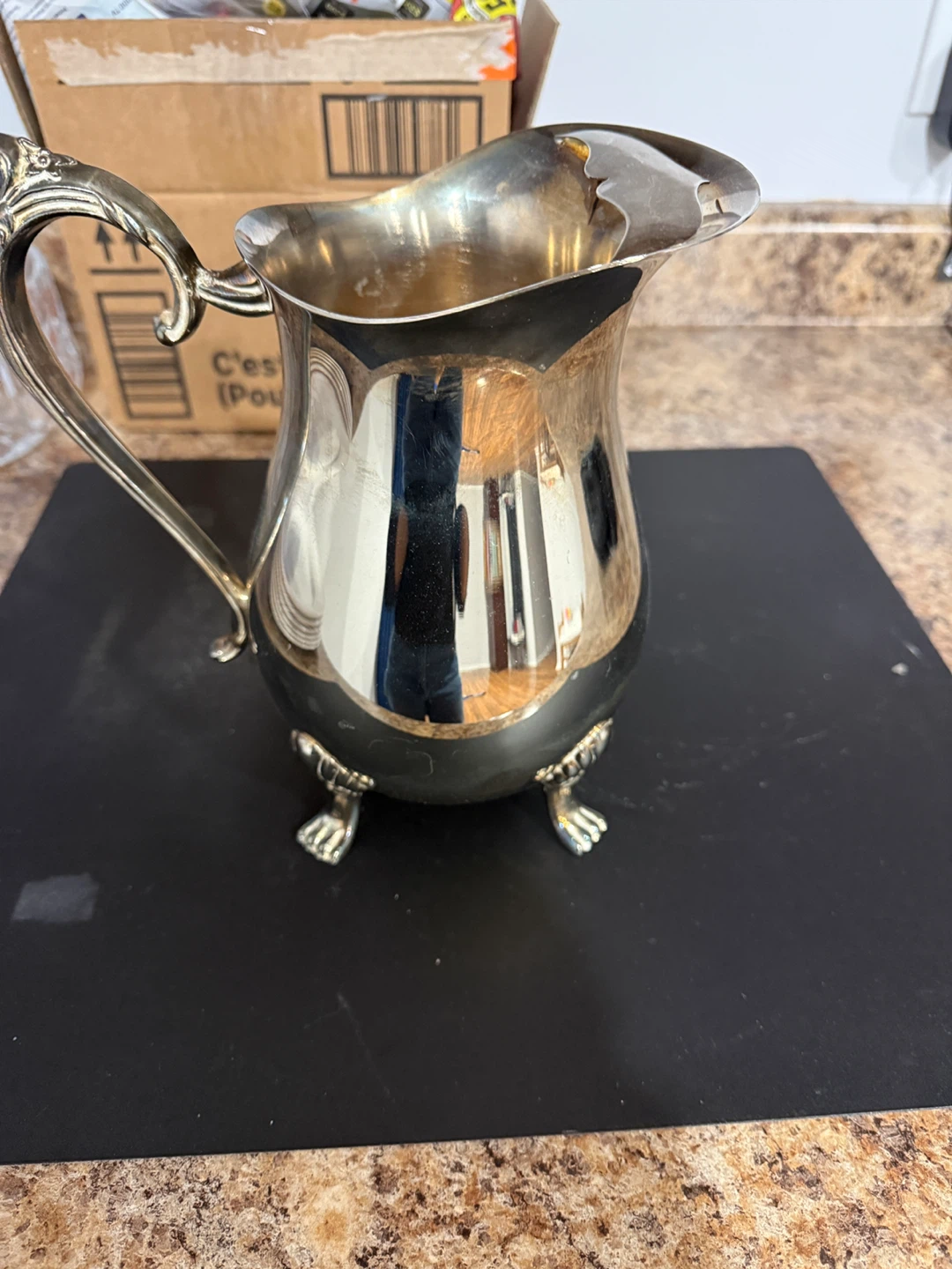Silver Pitcher with ornate handle and feet