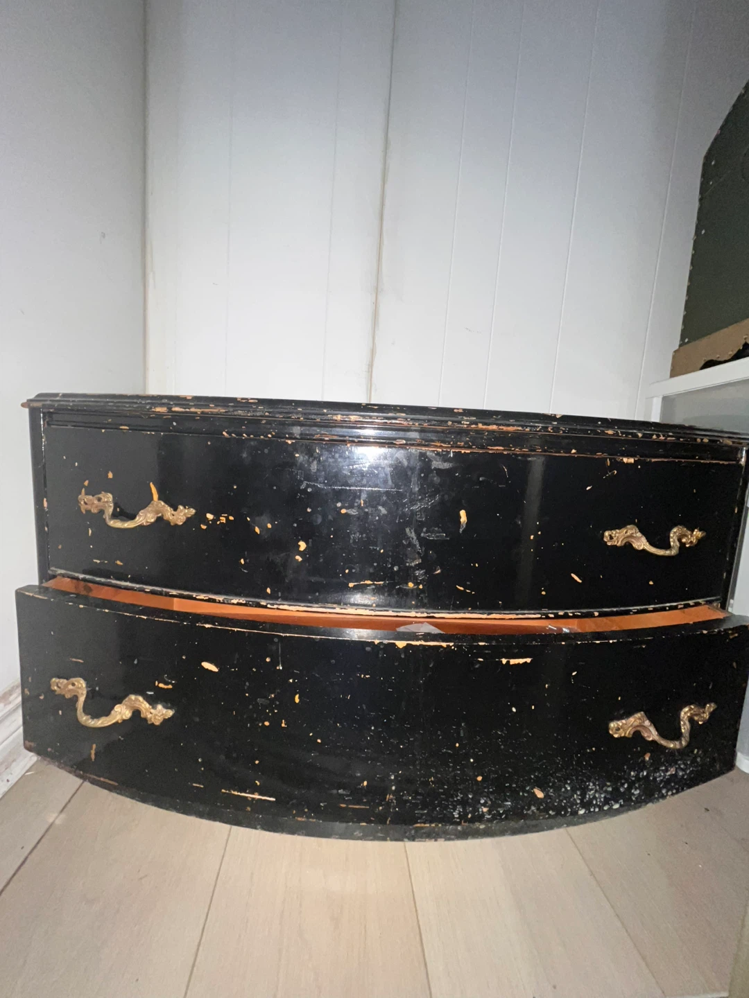 Black curved dresser with ornate handles