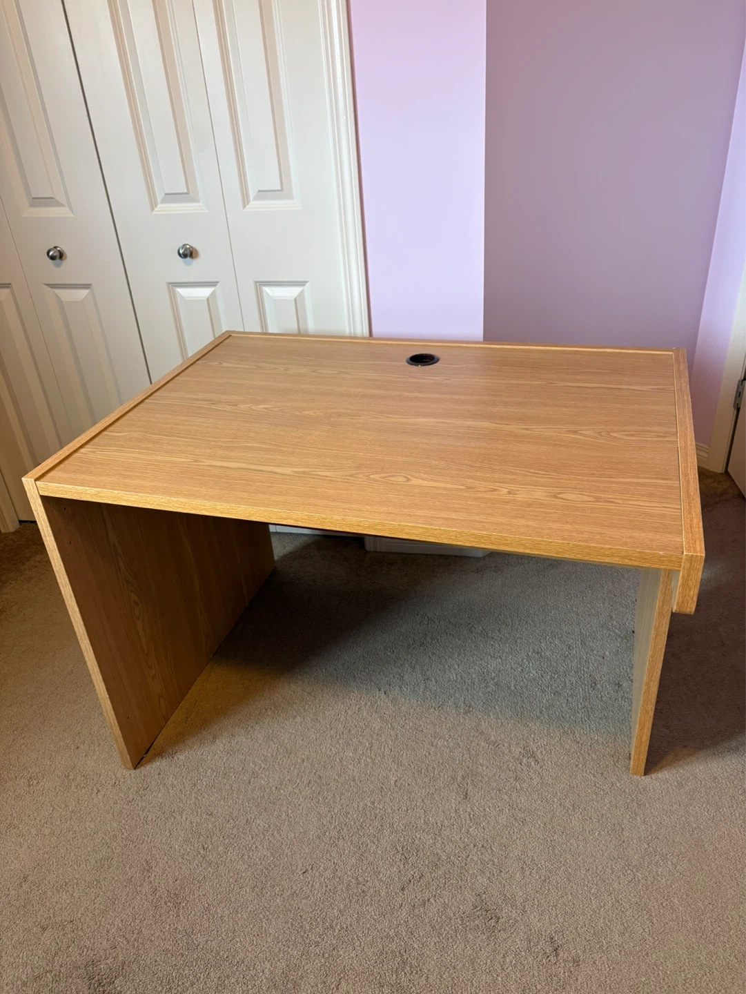 Oak finish desk with cable management hole