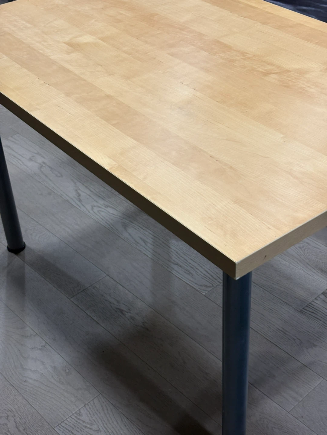Light wood dining table with metal legs