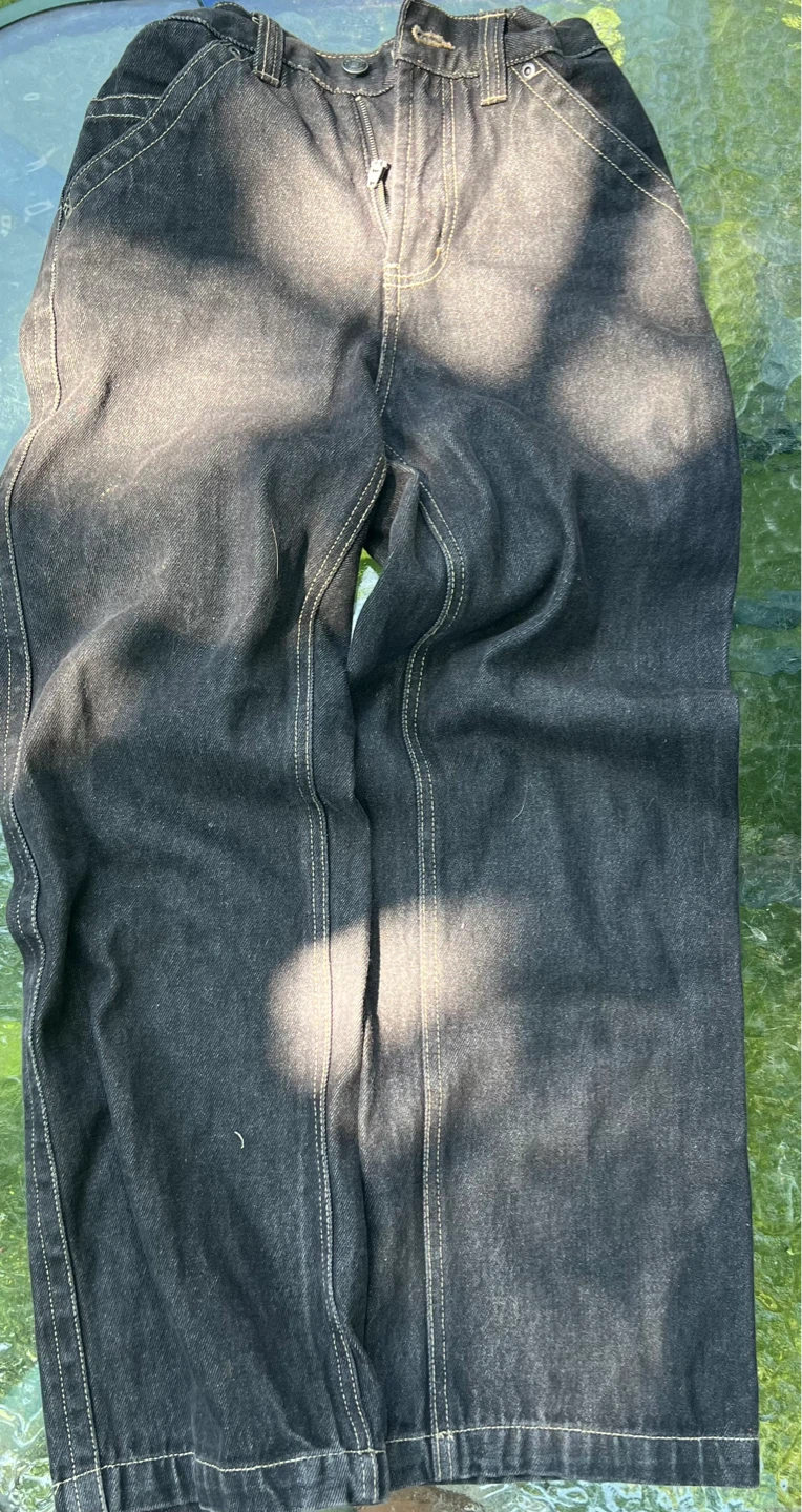 Black denim jeans with stitching and adjustable waistband