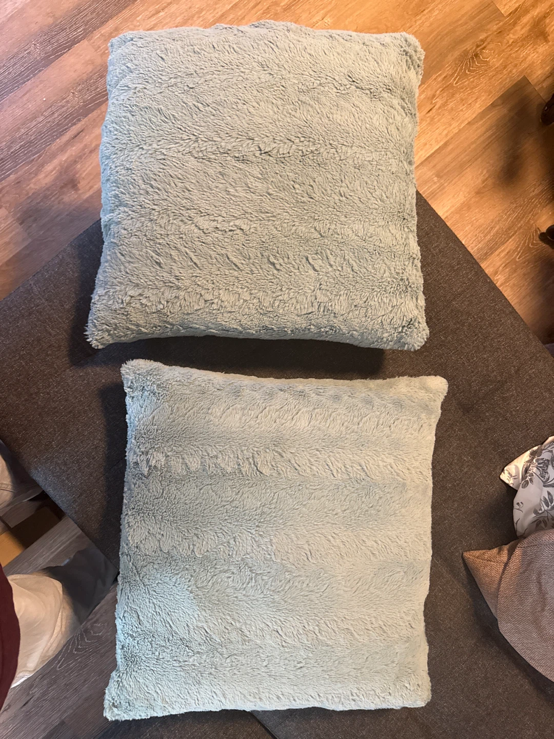 Set of 2 light blue/teal fuzzy throw pillows
