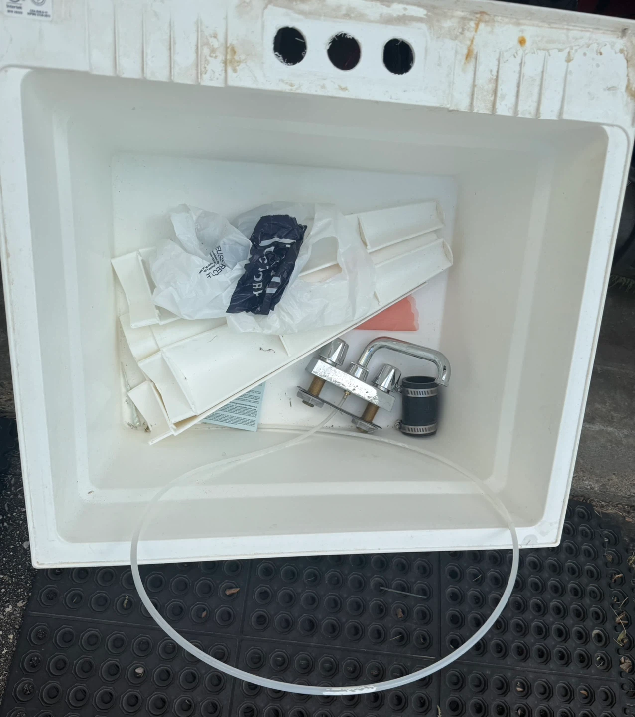 White Utility Sink with Faucet and Plumbing