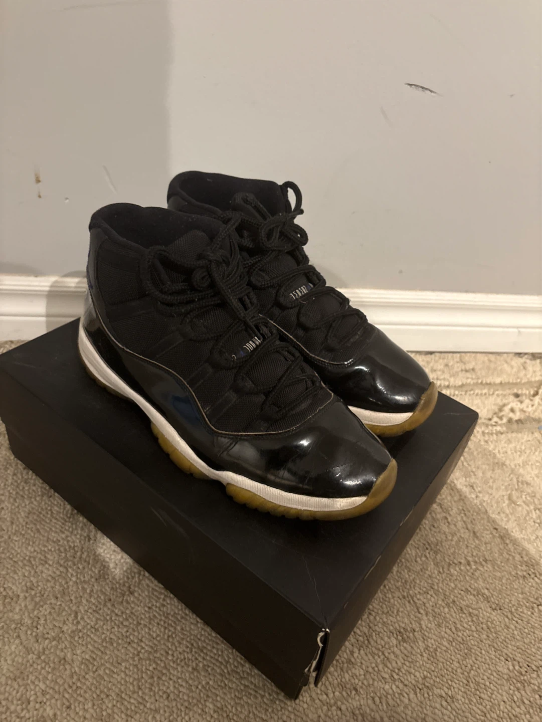 Air Jordan 11 Black Patent Leather Sneakers