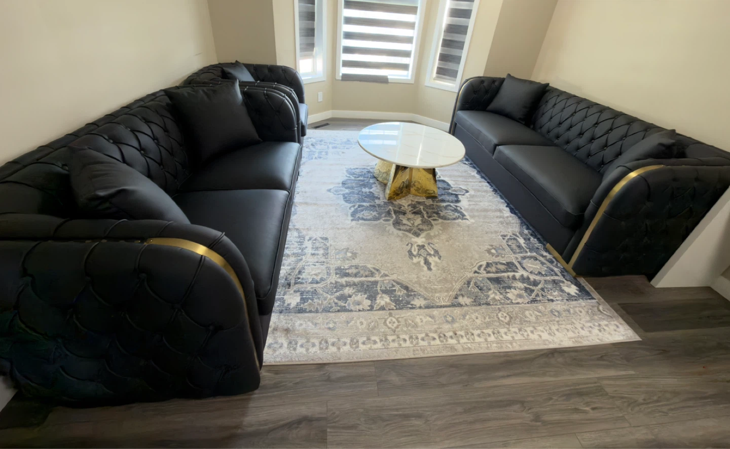 Black Tufted Sofa with Gold Accents