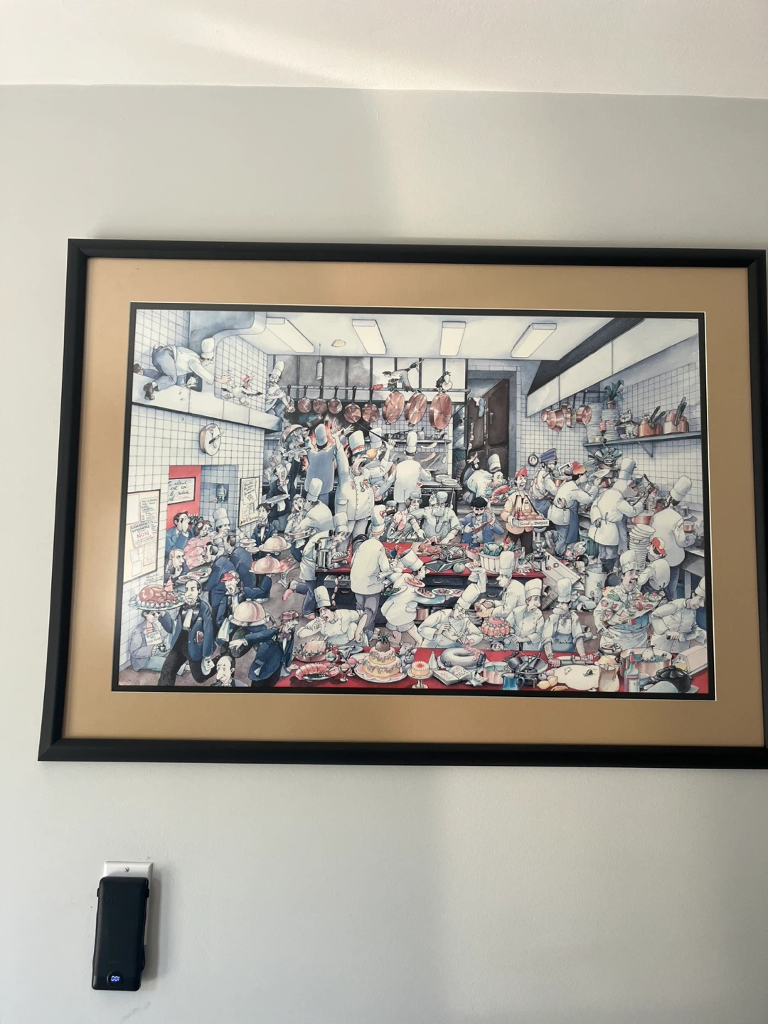 Framed print of a busy kitchen scene