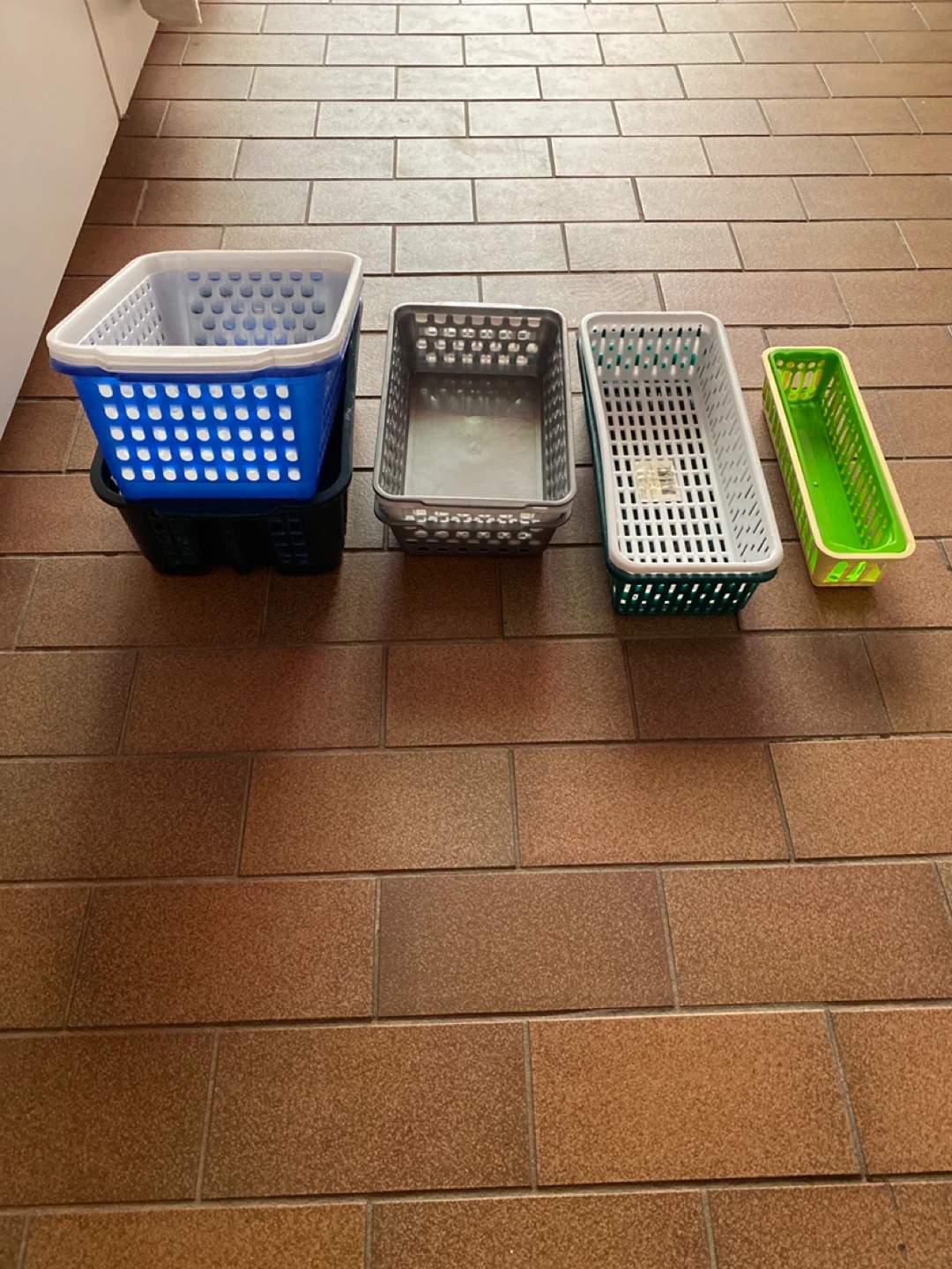 13 assorted plastic storage baskets