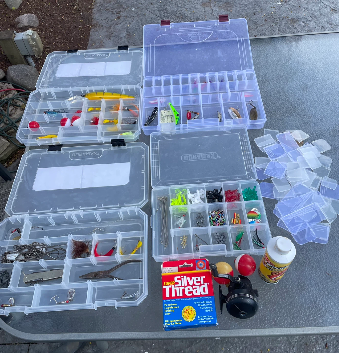 Fishing Tackle Box with Assorted Lures, Hooks, and Line