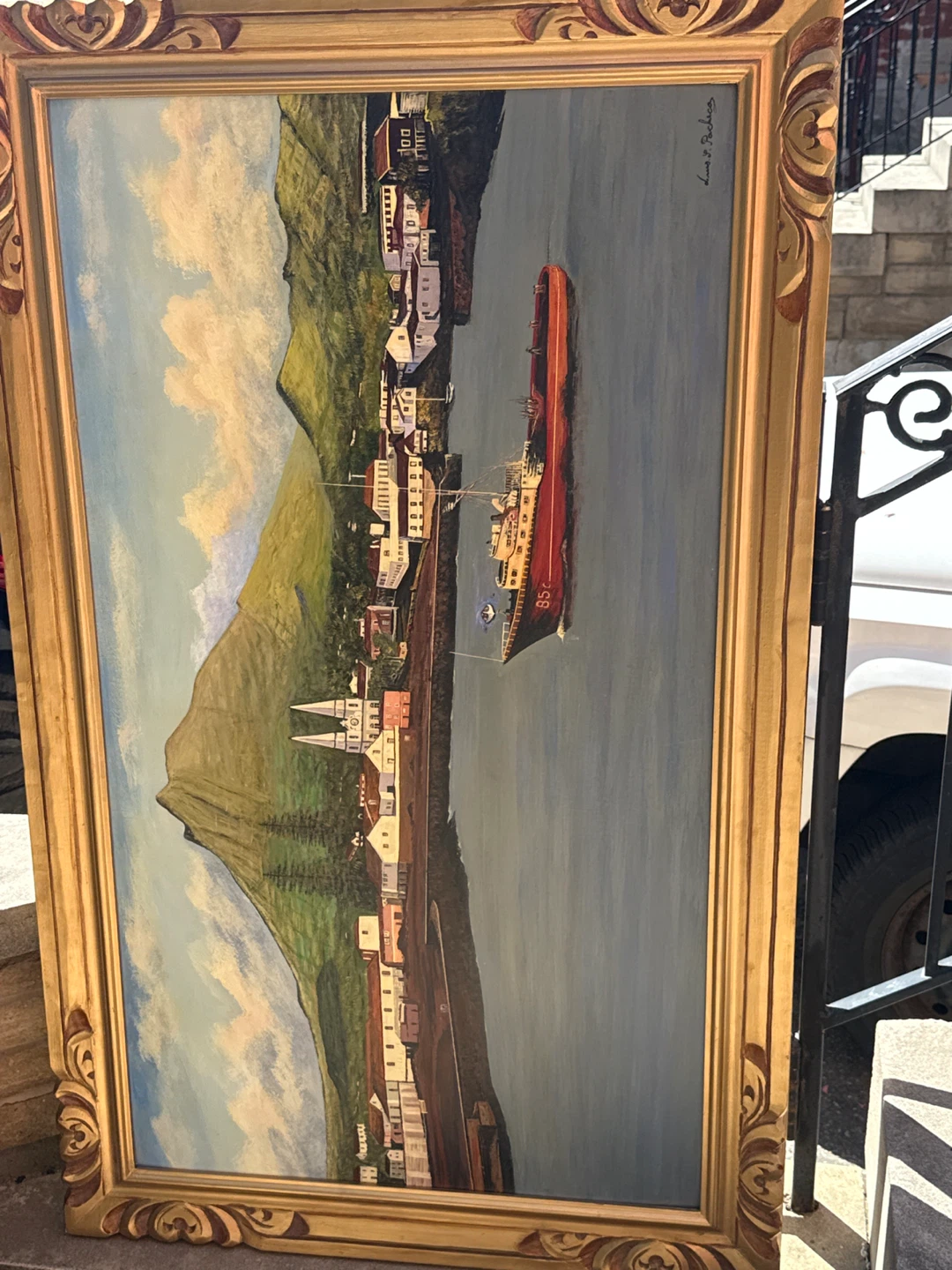 Framed Painting of a Coastal Town and Ship