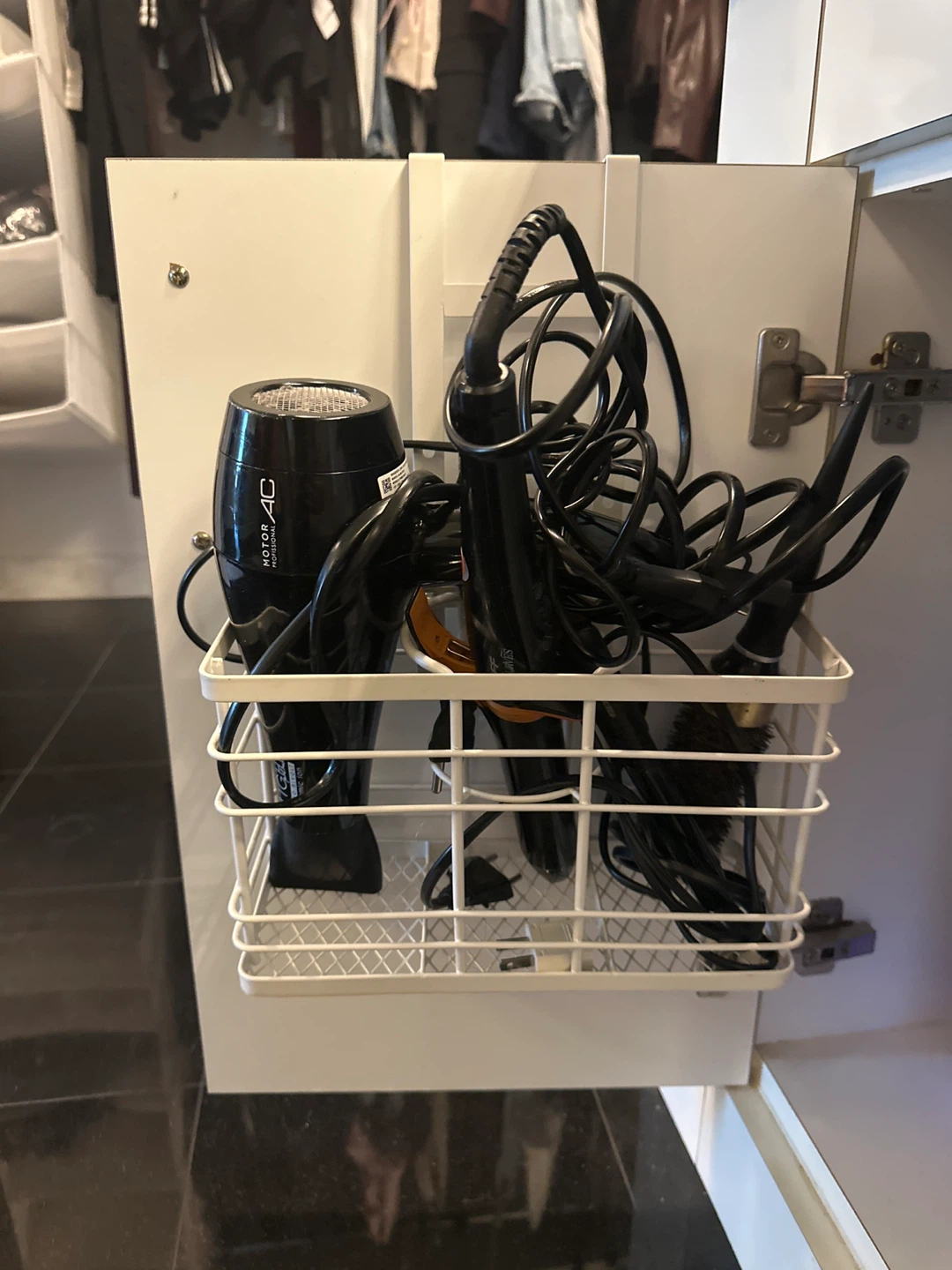White wire basket for organizing hair styling tools