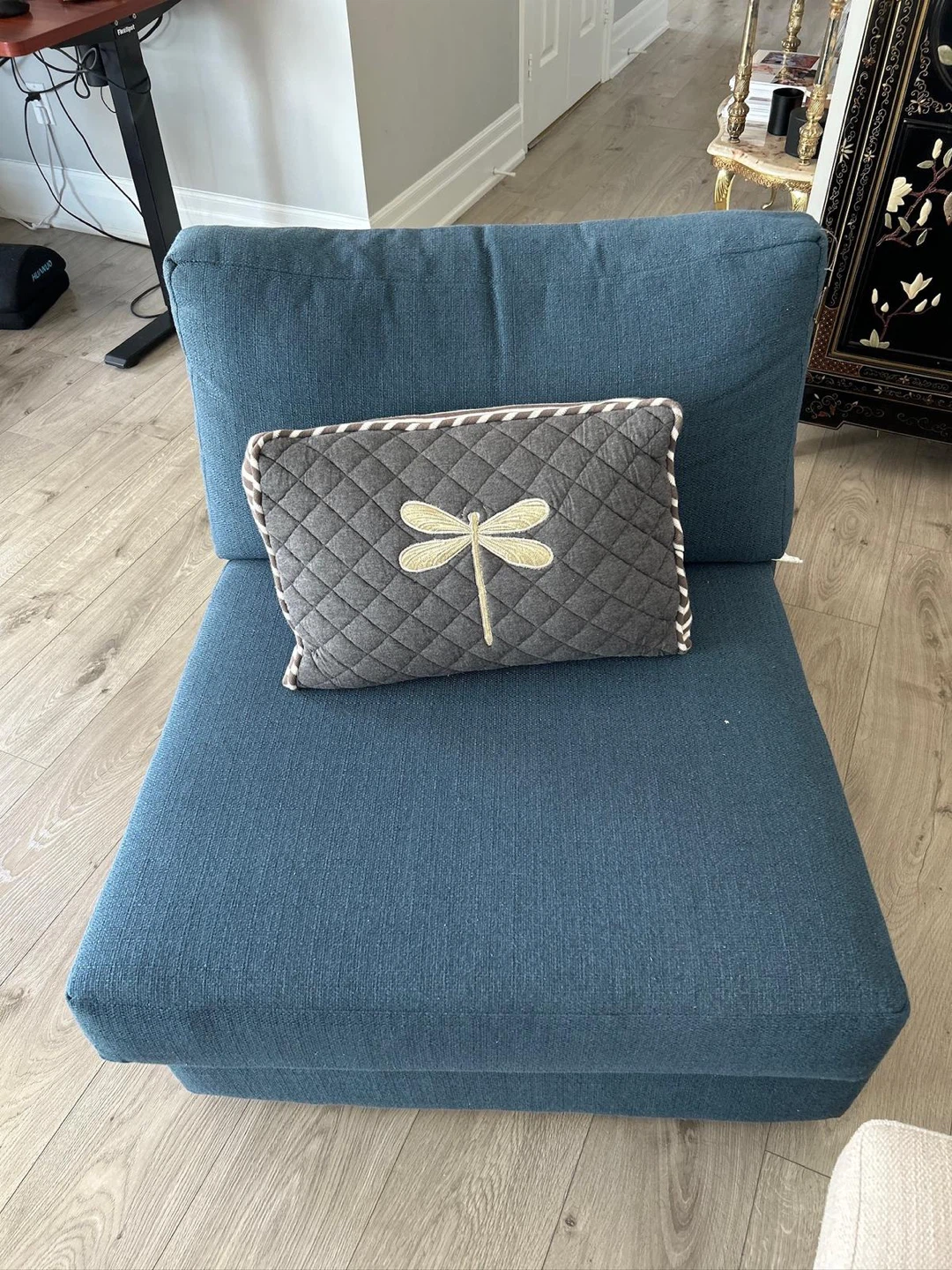 Blue accent chair with decorative pillow