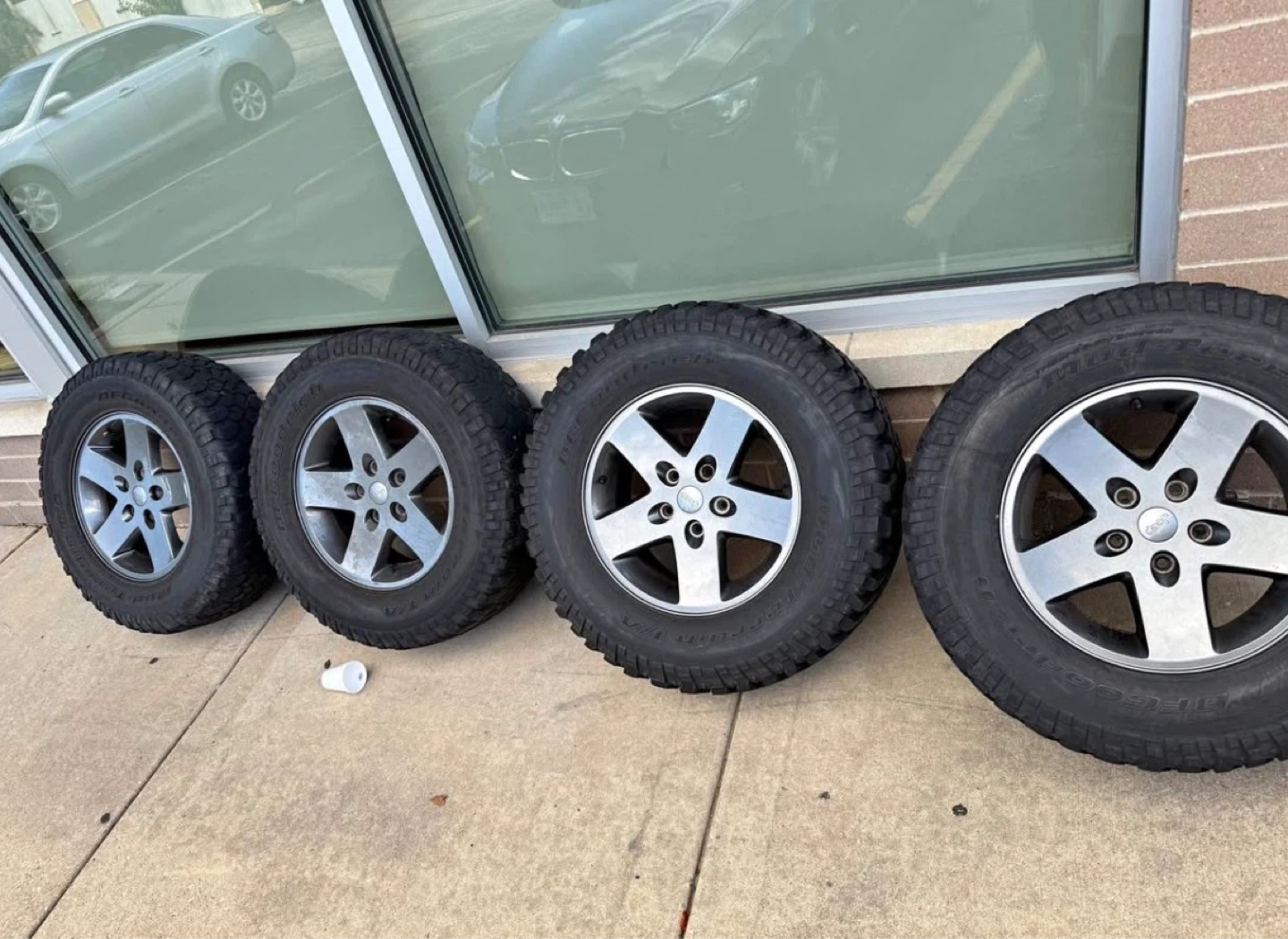 Set of 4 JKU oem rims and mud terrain t/a tires,2 need replacing