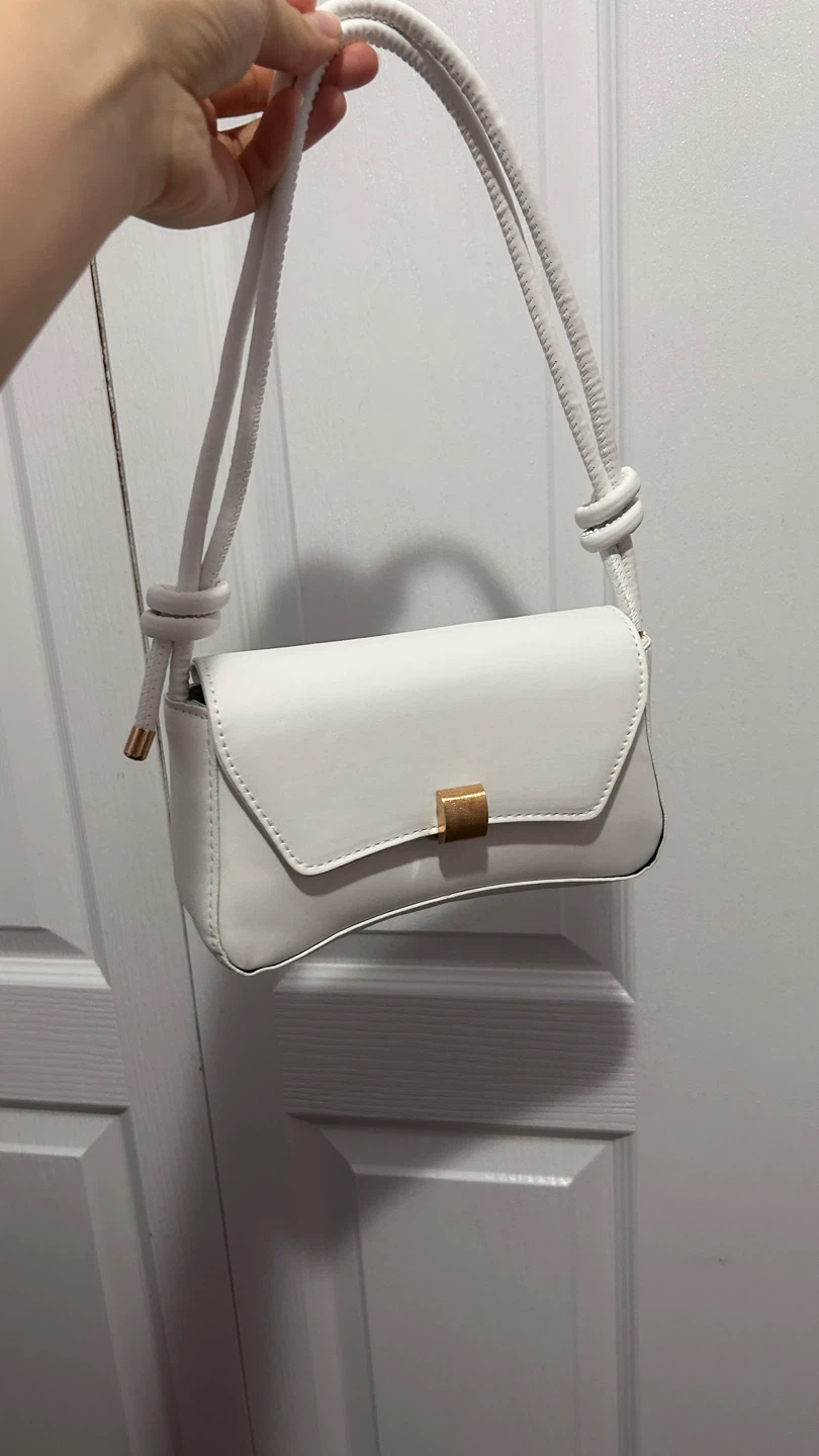White shoulder bag with gold hardware