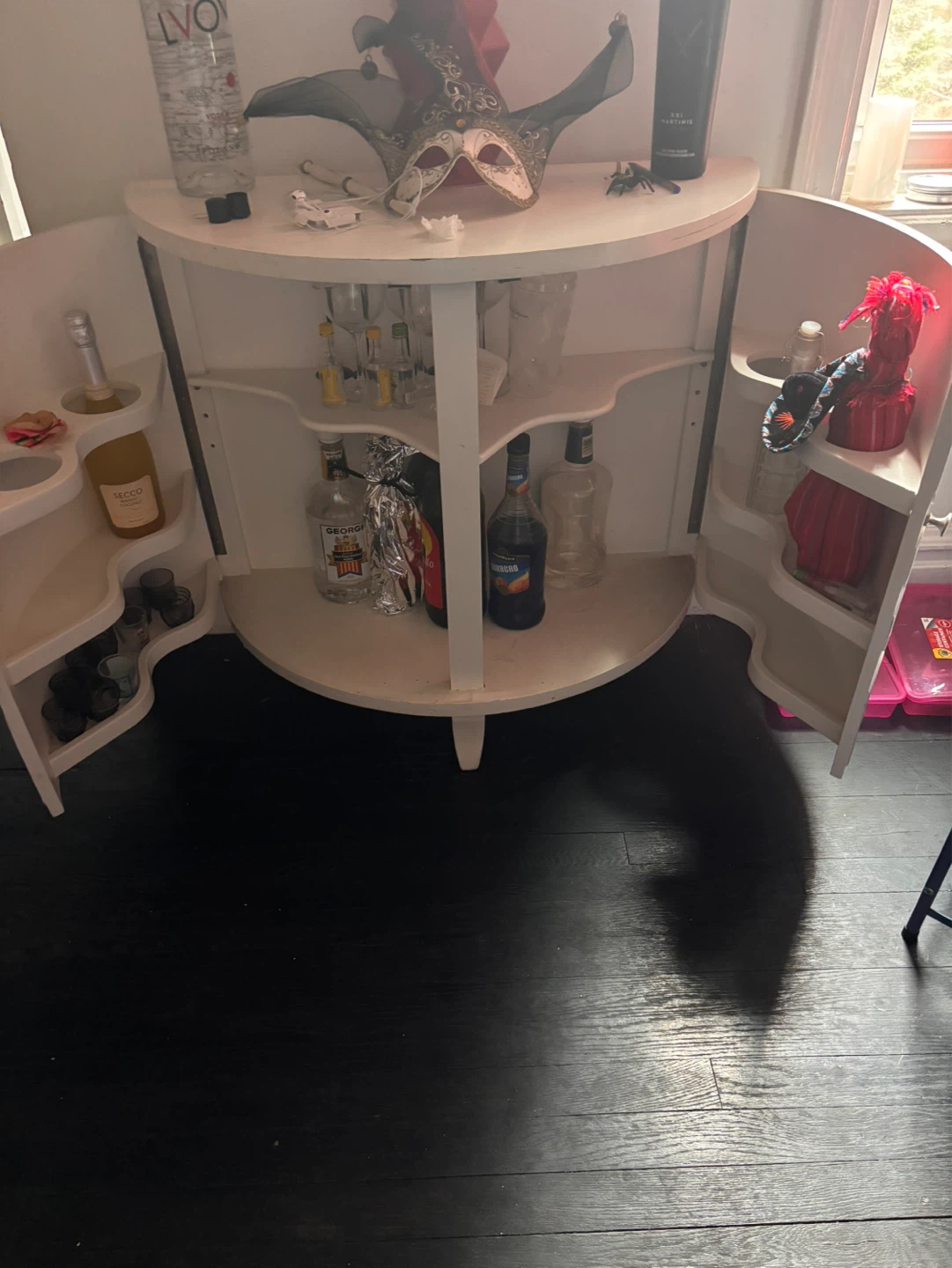 White Bar Cabinet with Glassware and Bottles