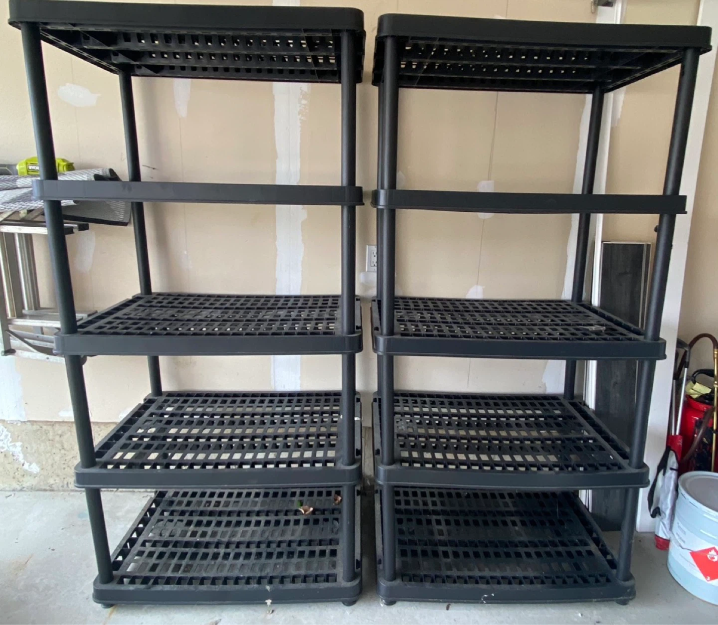 Two black plastic shelving units