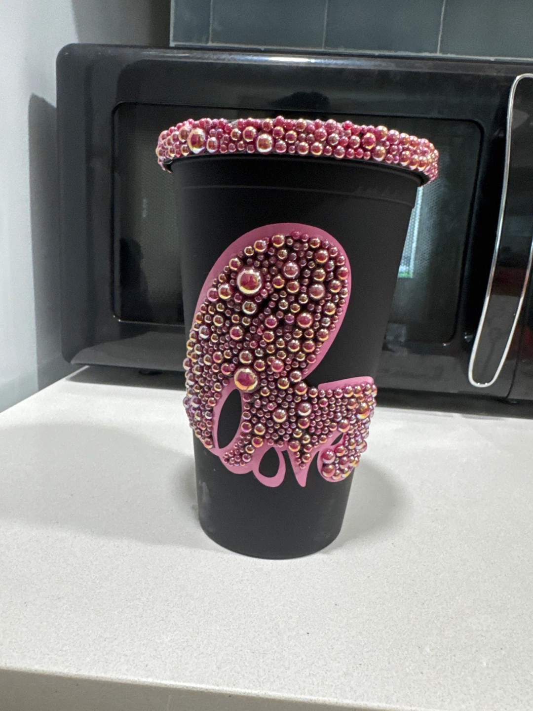 Black cup with pink rhinestones