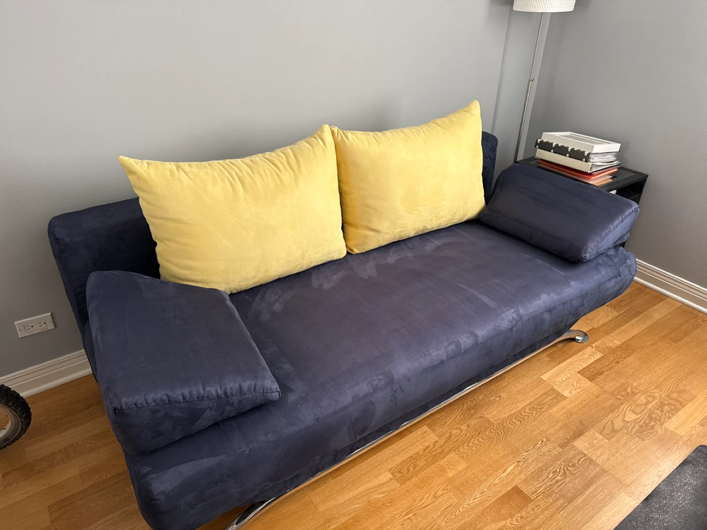 Navy Blue Sofa with Yellow Pillows