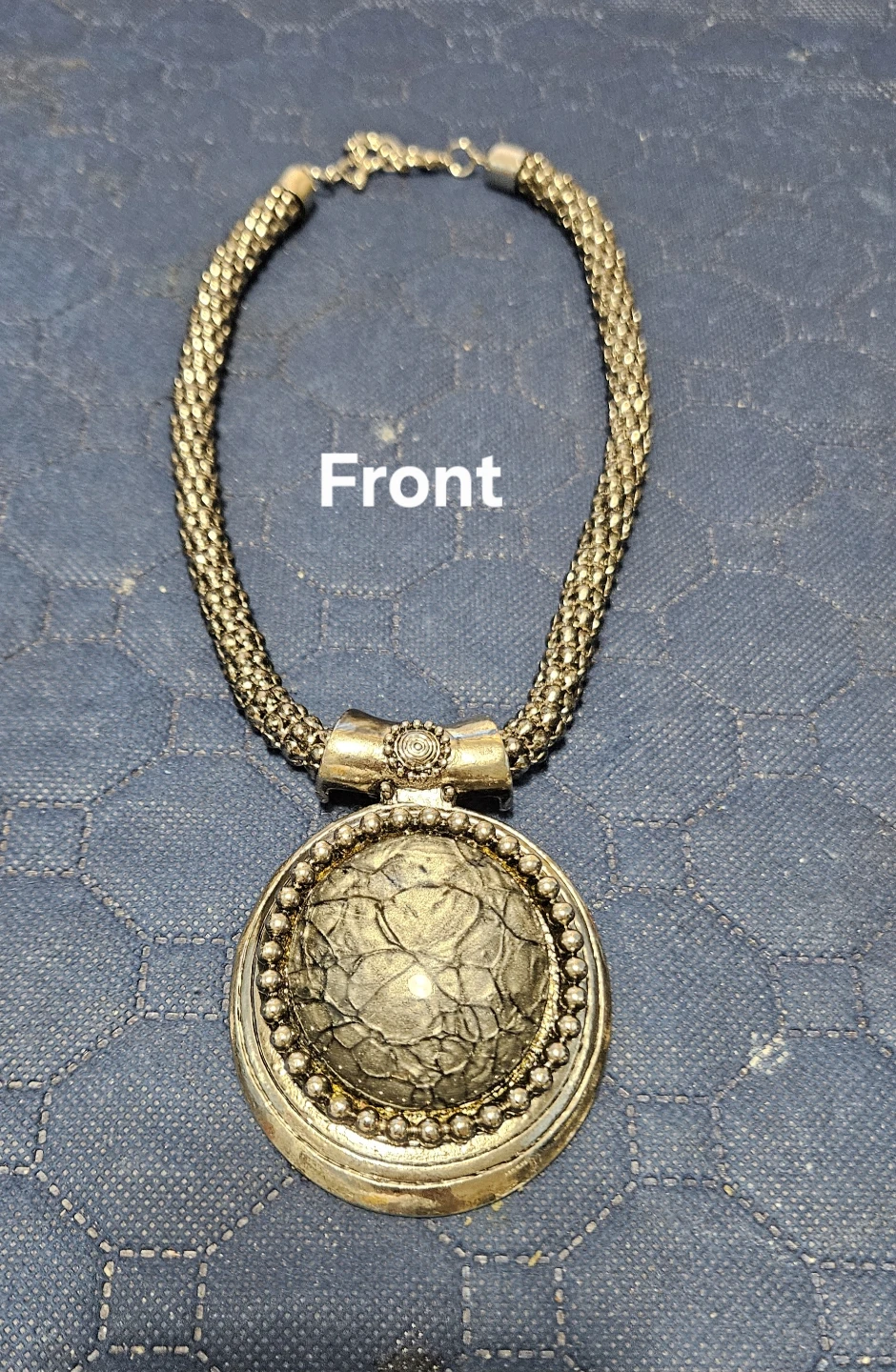 Silver tone statement necklace with large pendant