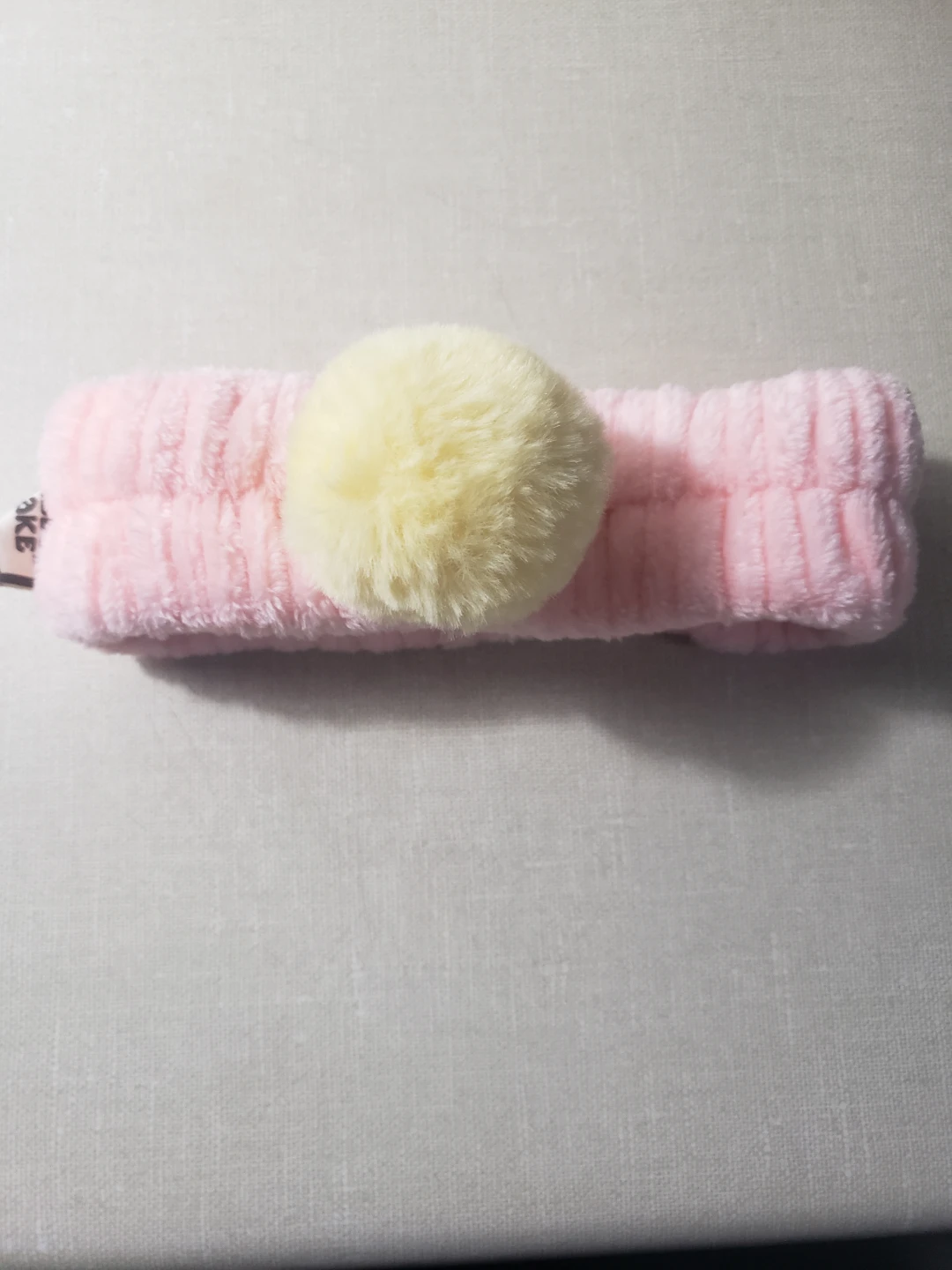 Pink fuzzy headband with pom-pom