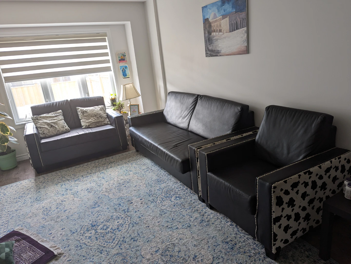 Black faux leather couch and armchair set with cow print accents
