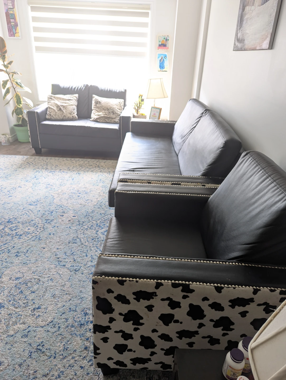Black faux leather couch and armchair set with cow print accents - photo 3