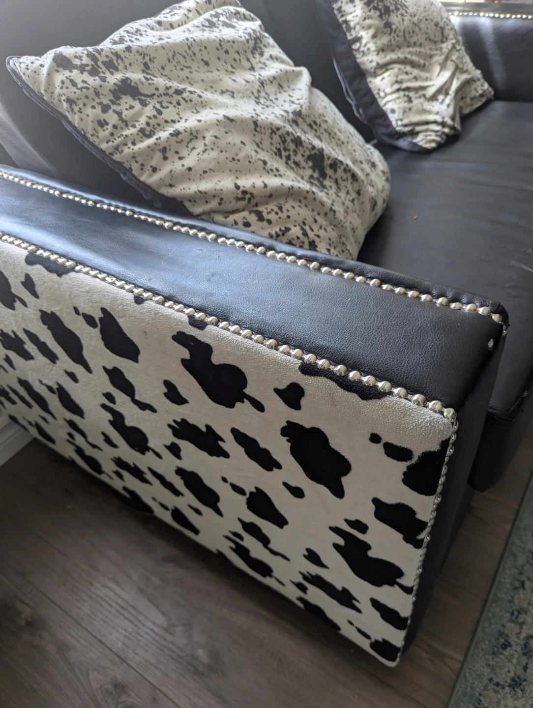 Black faux leather couch and armchair set with cow print accents - photo 4