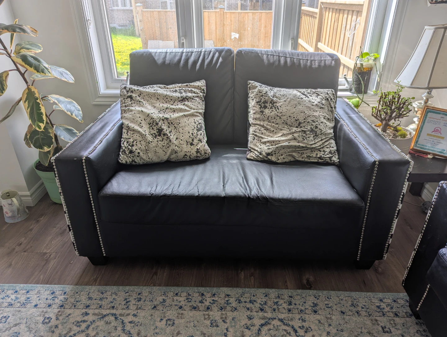 Black faux leather couch and armchair set with cow print accents - photo 5